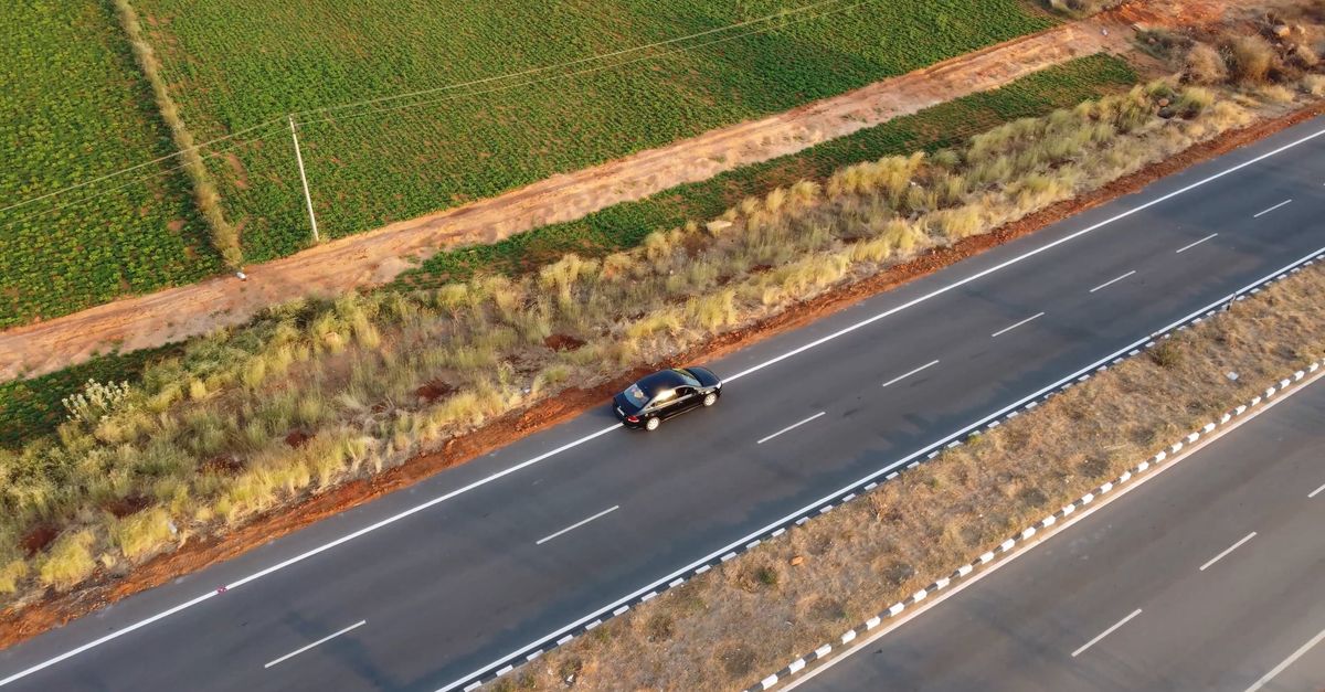 Car Rode View An aerial view of a road with a car driving down it Free Stock Video ...