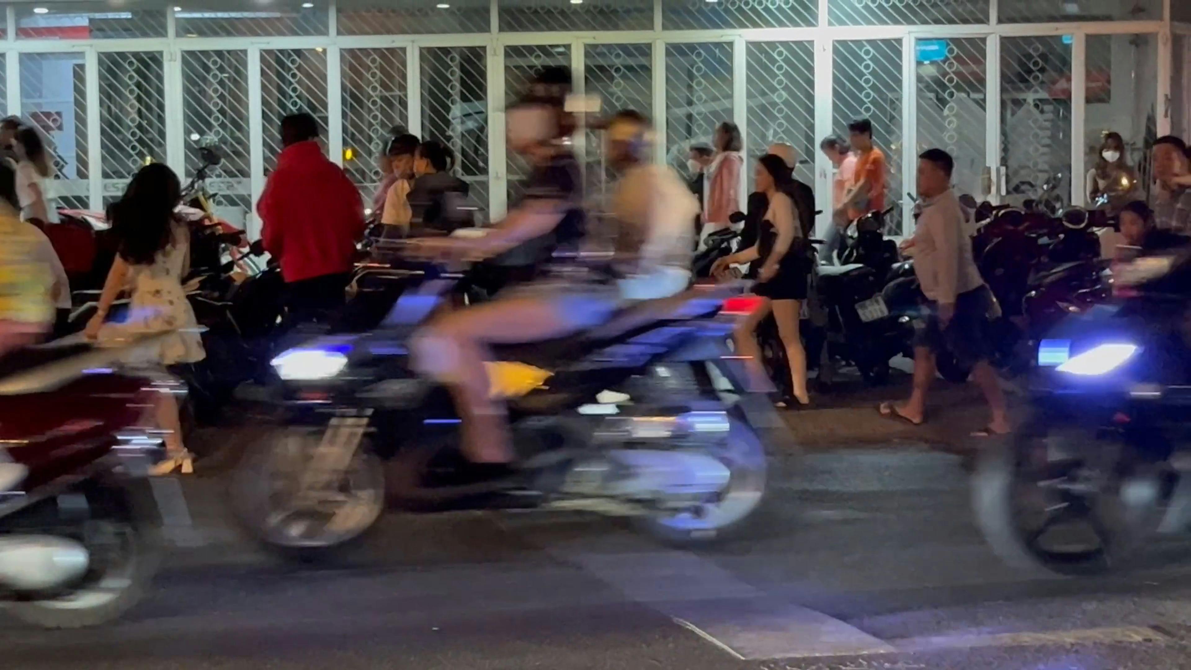 a group of people riding motorcycles at night 20235065