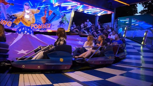 People Enjoying A Ride At The Carnival