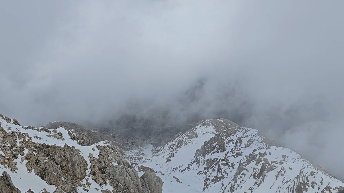 A view of a snowy mountain with a cloud in the sky Free Stock Video ...