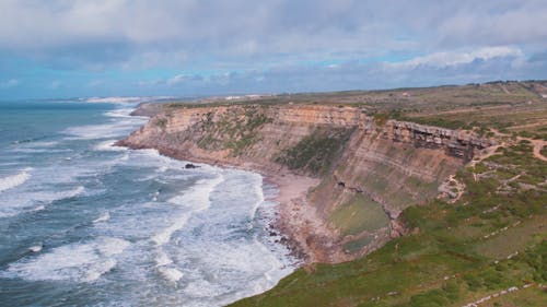 Drone Footage of Hidden Beach near Magoito and Green Cliffs in Sintra, Portugal