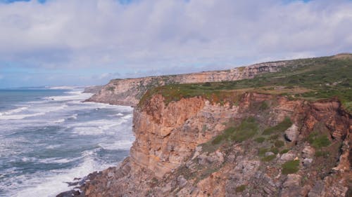 Sweeping Drone Views of Magoito's Cliffs Meeting the Blue Atlantic Ocean