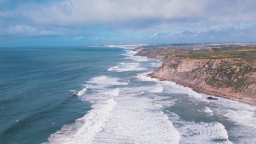 Panoramic Aerial Exploration Over Magoito's Verdant Cliffs and Atlantic Ocean in Sintra, Portugal