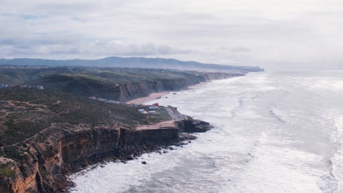 Drone Footage of Waves at Magoito Beach on a Cloudy Day, Portugal