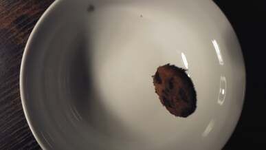 a bowl of cookies being thrown into the air