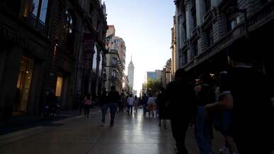 a man walks down a street in a city