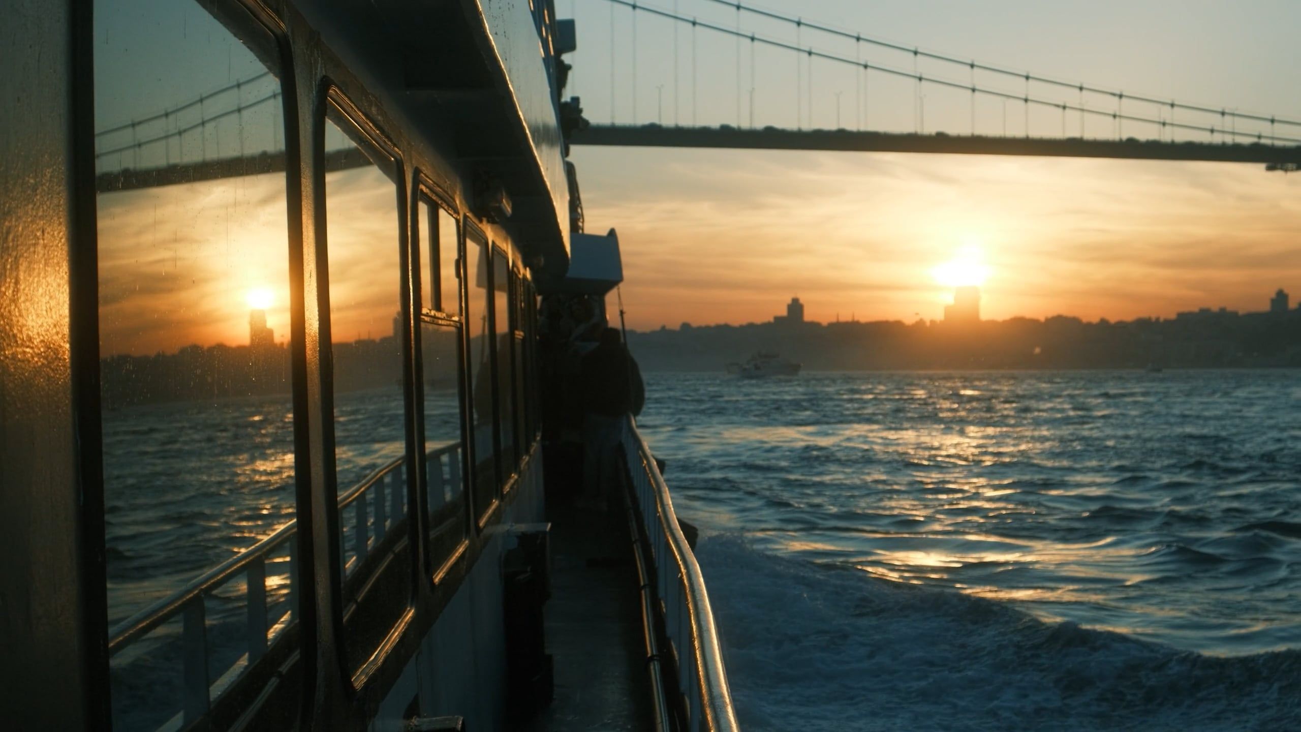 A boat is sailing across the water with the sun setting Free Stock ...