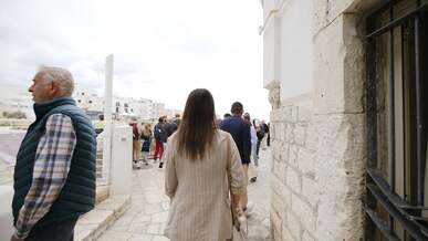 a group of people walking on a stone walkway