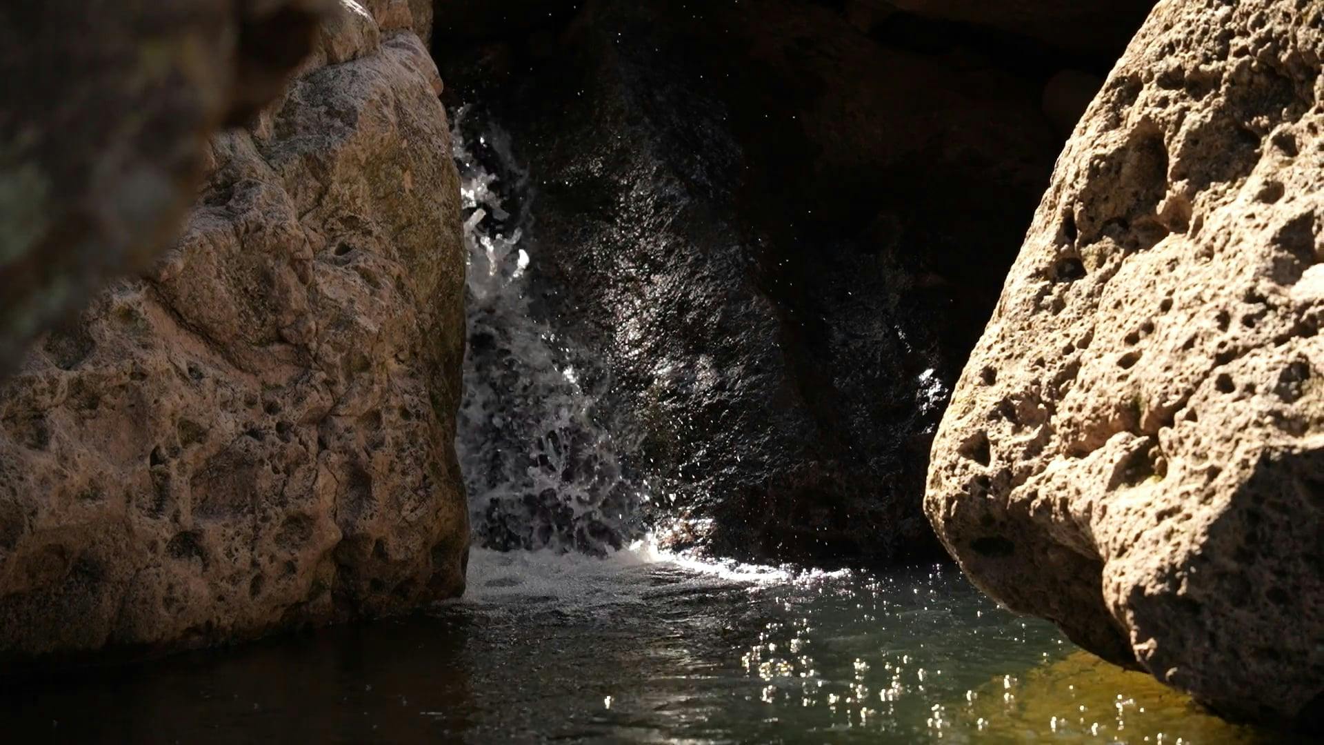 a small waterfall in a rocky area 20692849