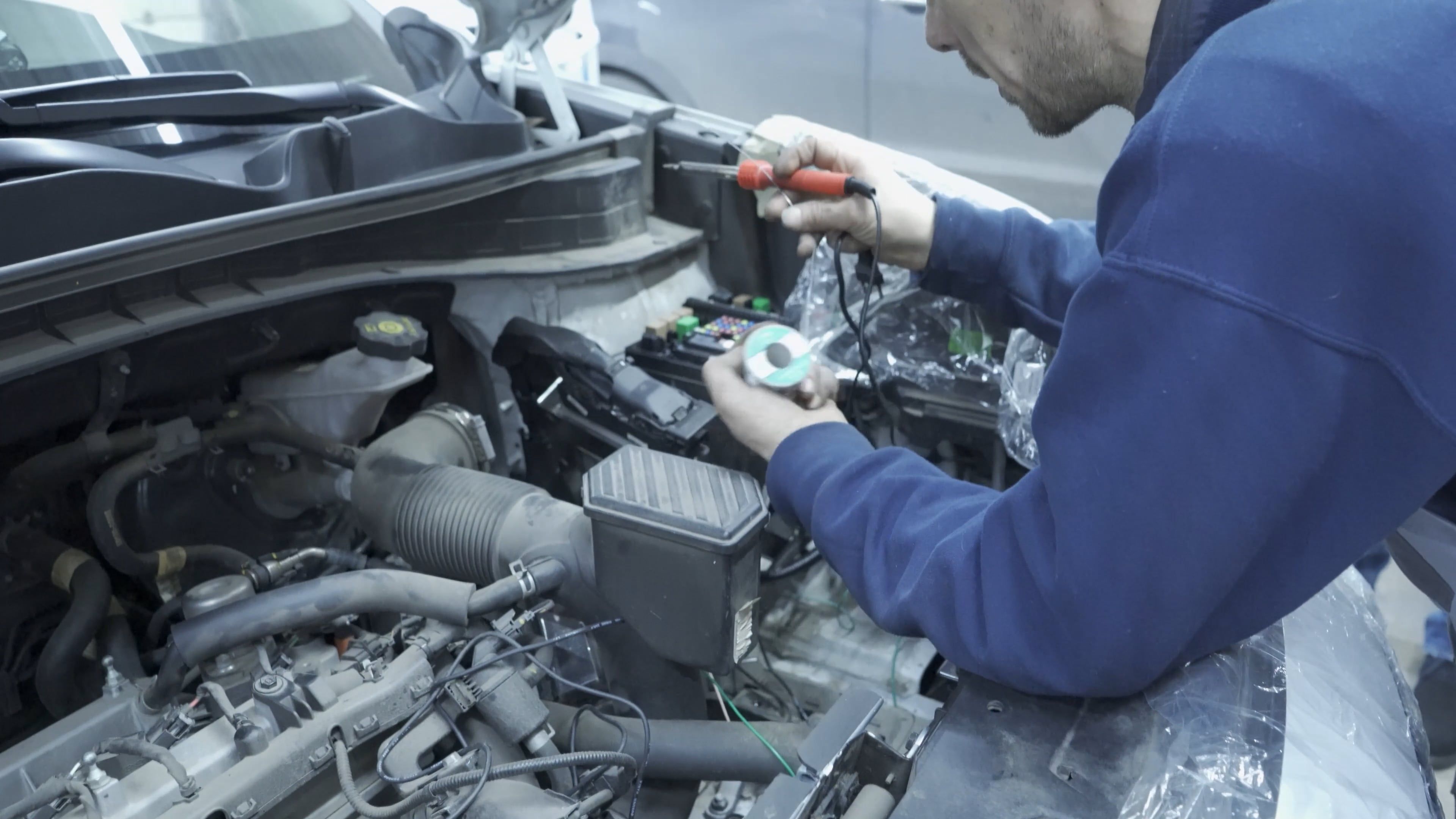 A man is working on the engine of a car Free Stock Video Footage ...