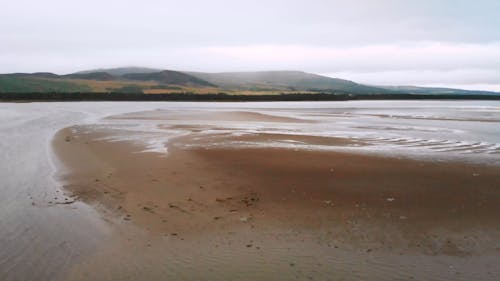 Low drone flight over Scottish beach