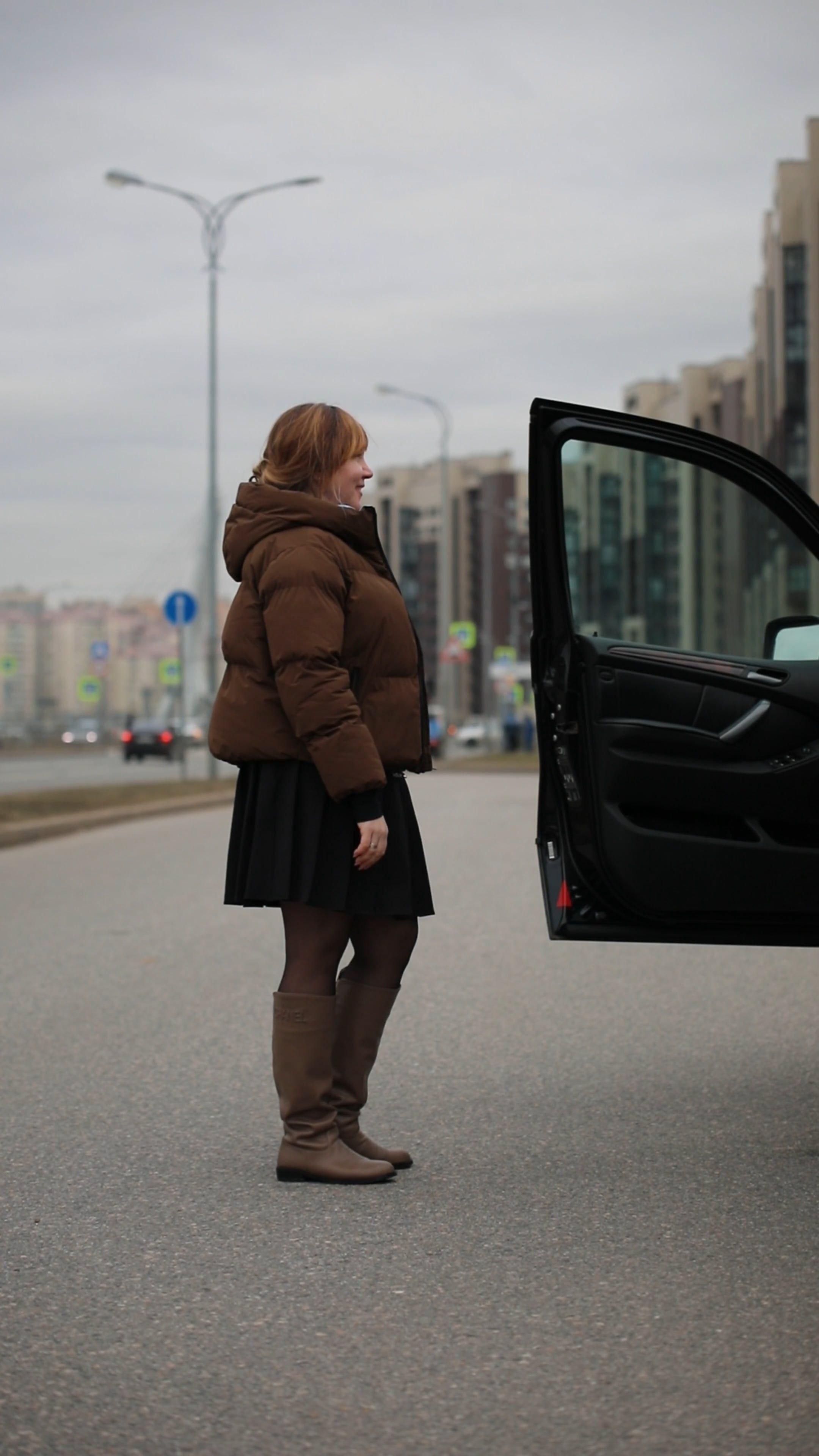 A woman standing in front of a car on a city street Free Stock Video ...