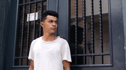 Young Man Taking Pictures At The Front Door