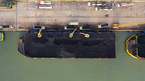 Transferring Black Sand From Barges