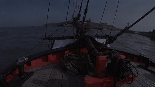 A Boat Entering The Breakwater On A Rainy Day