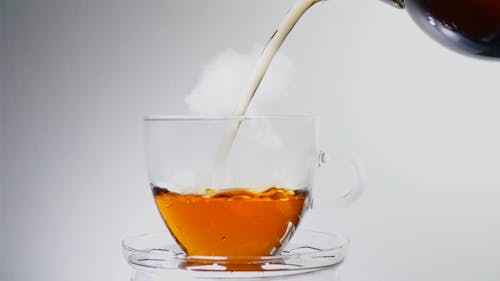 Pouring Tea On Teacup