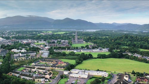 Aerial Footage Of A Town Surrounded By Scenic Natural Landscape