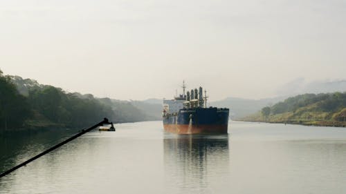 Ship Sailing Across The River