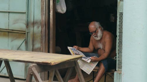 A Man Reading A Newspaper