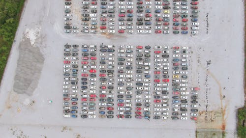View From Above Of Rows Of Broken Vehicles Parked In A Junkyard