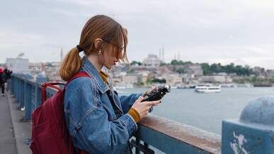 a woman with a backpack looking at the city
