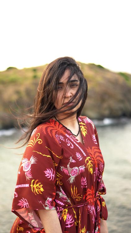 A woman in a red dress standing on the beach Free Stock Video Footage ...