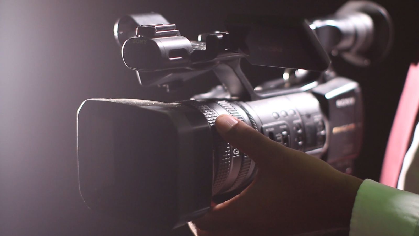A Person Adjusting A Video Camera Focus And Angle Free Stock Video ...