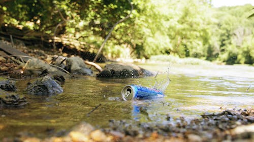Slow Motion Of  Empty Tin Can Floating On A Creek