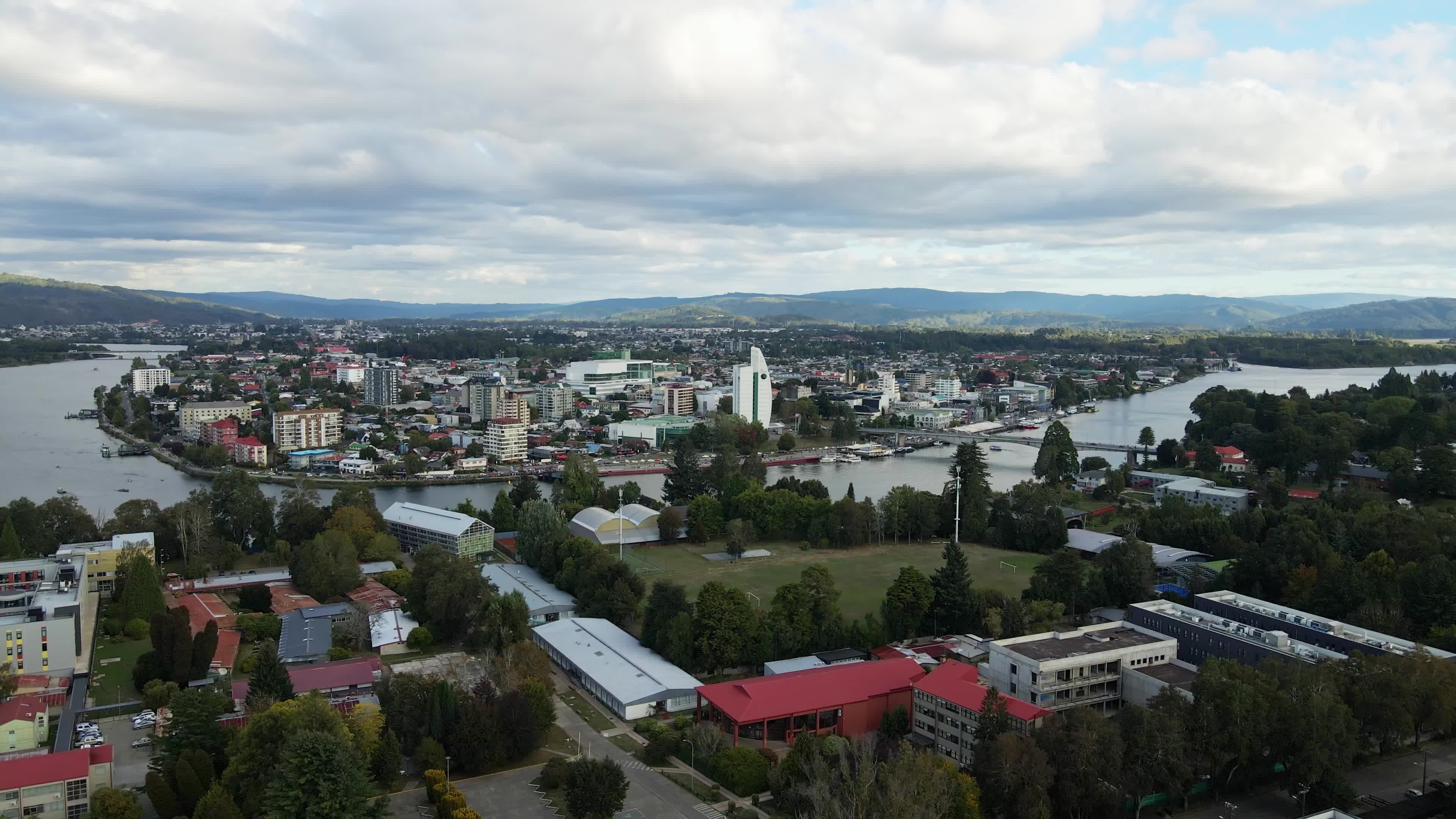 An aerial view of a city with a river and trees Free Stock Video ...