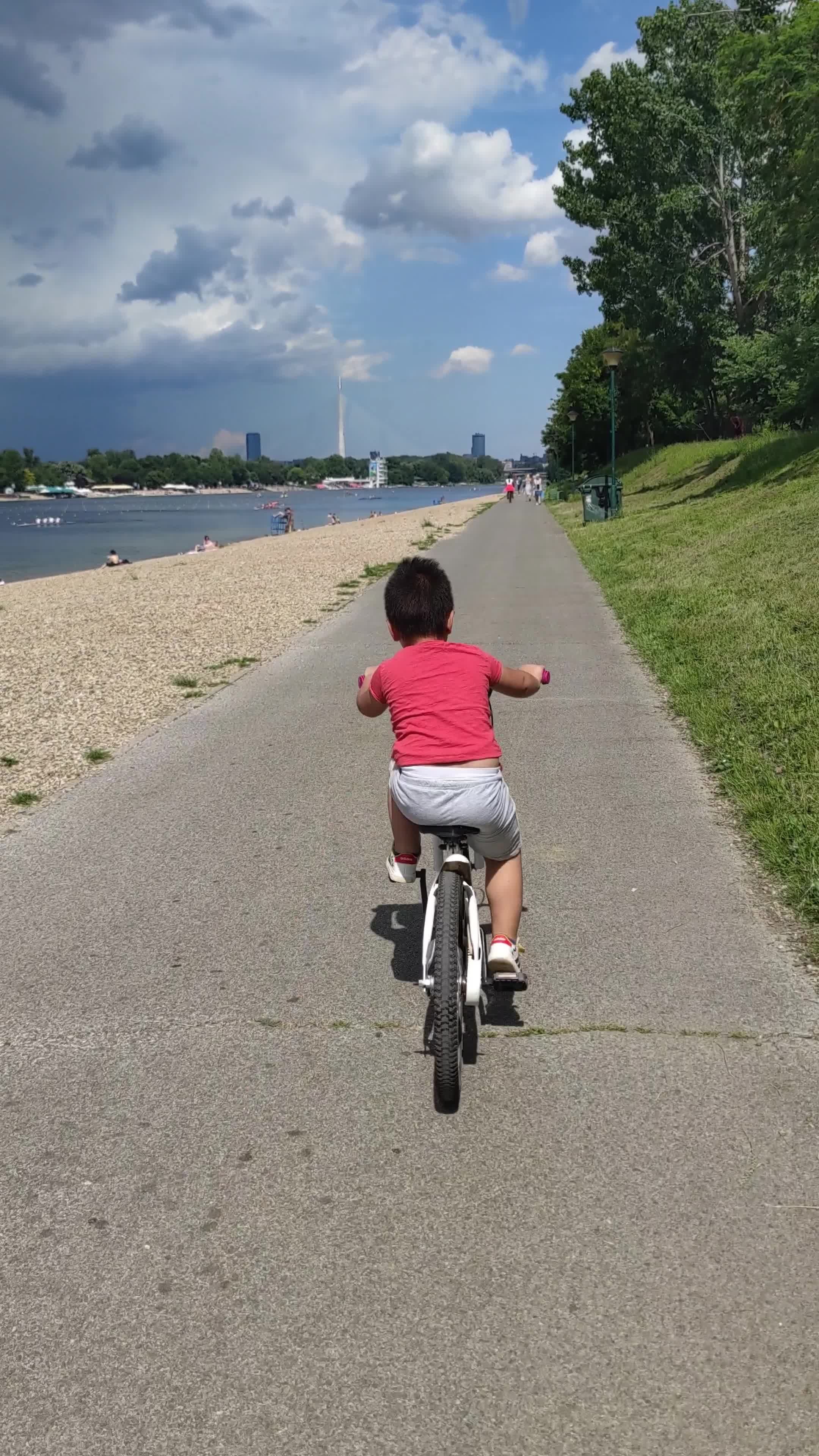 A child riding a bike on a path next to the water Free Stock Video ...