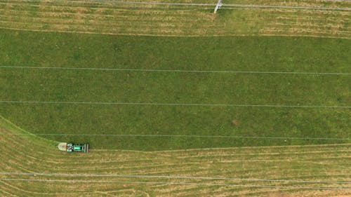  An Agricultural Tractor Maintaining A Land By Grass Mowing