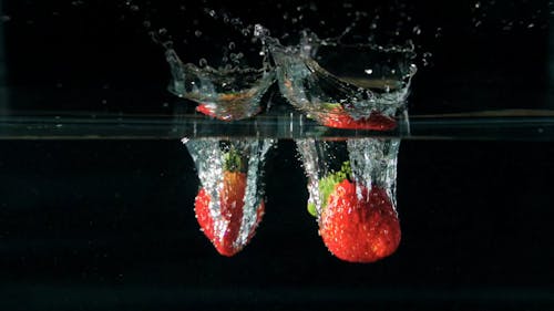 Strawberries Plunging Into Water