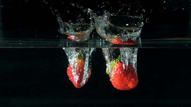 strawberries plunging into water
