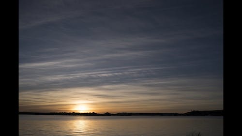 Time Lapse Footage Of The Skies Over A Lake From Dusk To Dawn