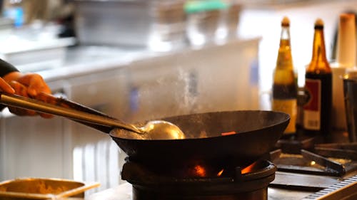 A Cook Using A Wok 