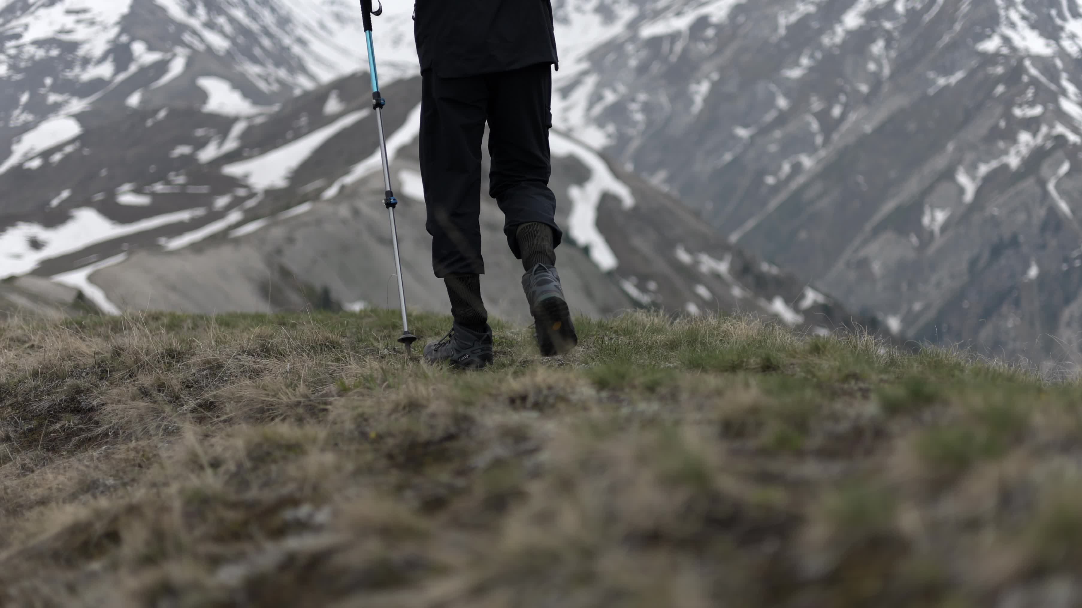 hiker with trekking poles walking high in snowy mountains almaty kazakhstan 26508101
