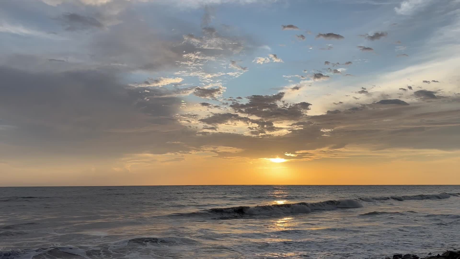 A sunset over the ocean with clouds and waves Free Stock Video Footage ...