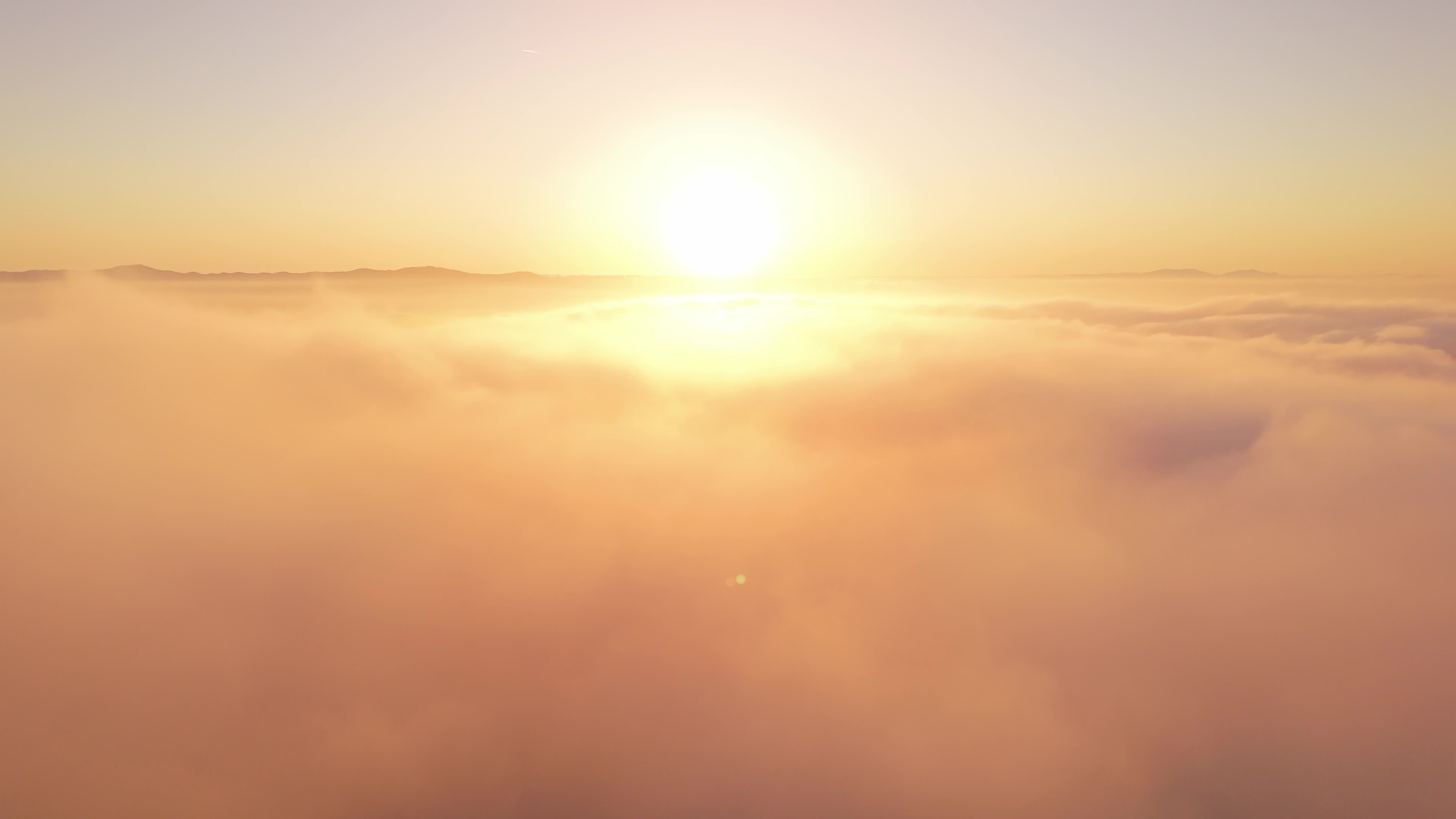 Aerial view of the sun rising over the clouds Free Stock Video Footage ...