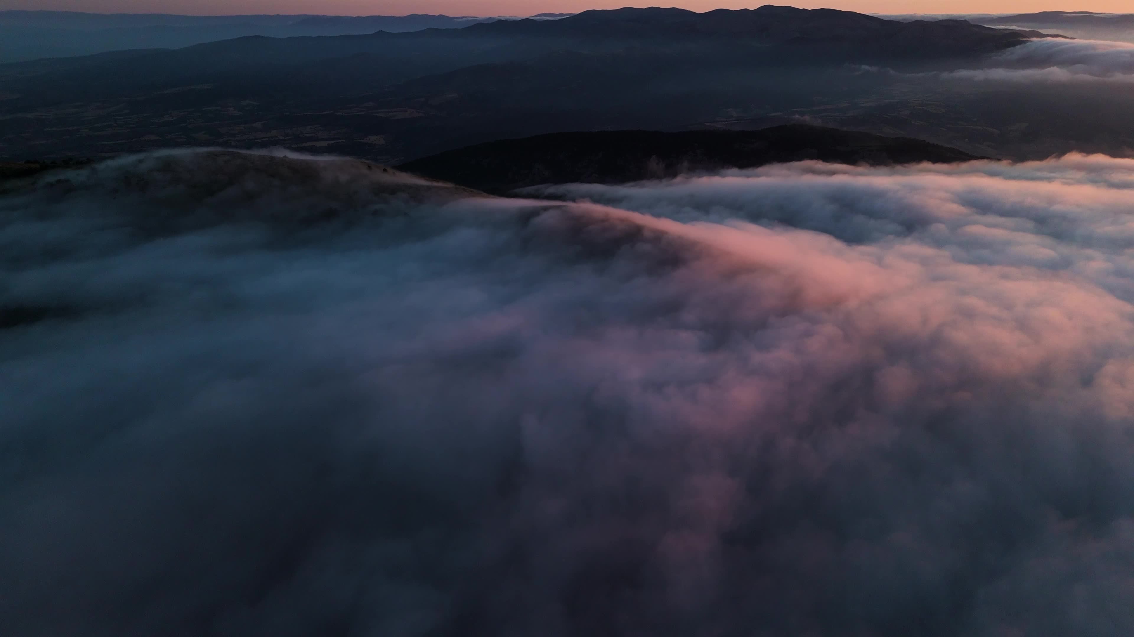 Aerial view of the fog and clouds over the mountains at sunset Free ...