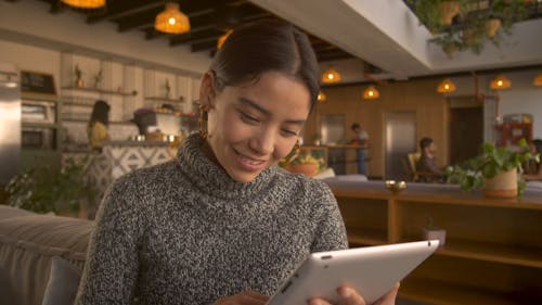 A Woman Working On An Electronic Tablet