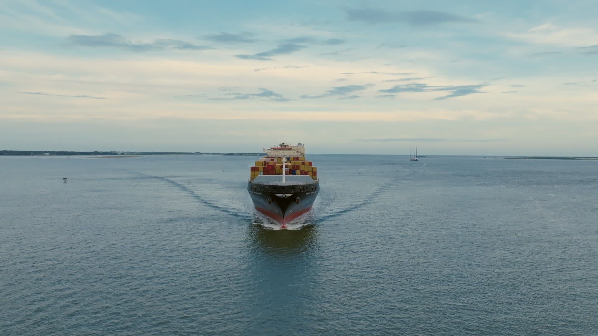 Aerial view of a container ship sailing through the ocean Free Stock ...
