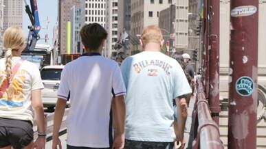 a group of people walking on a bridge
