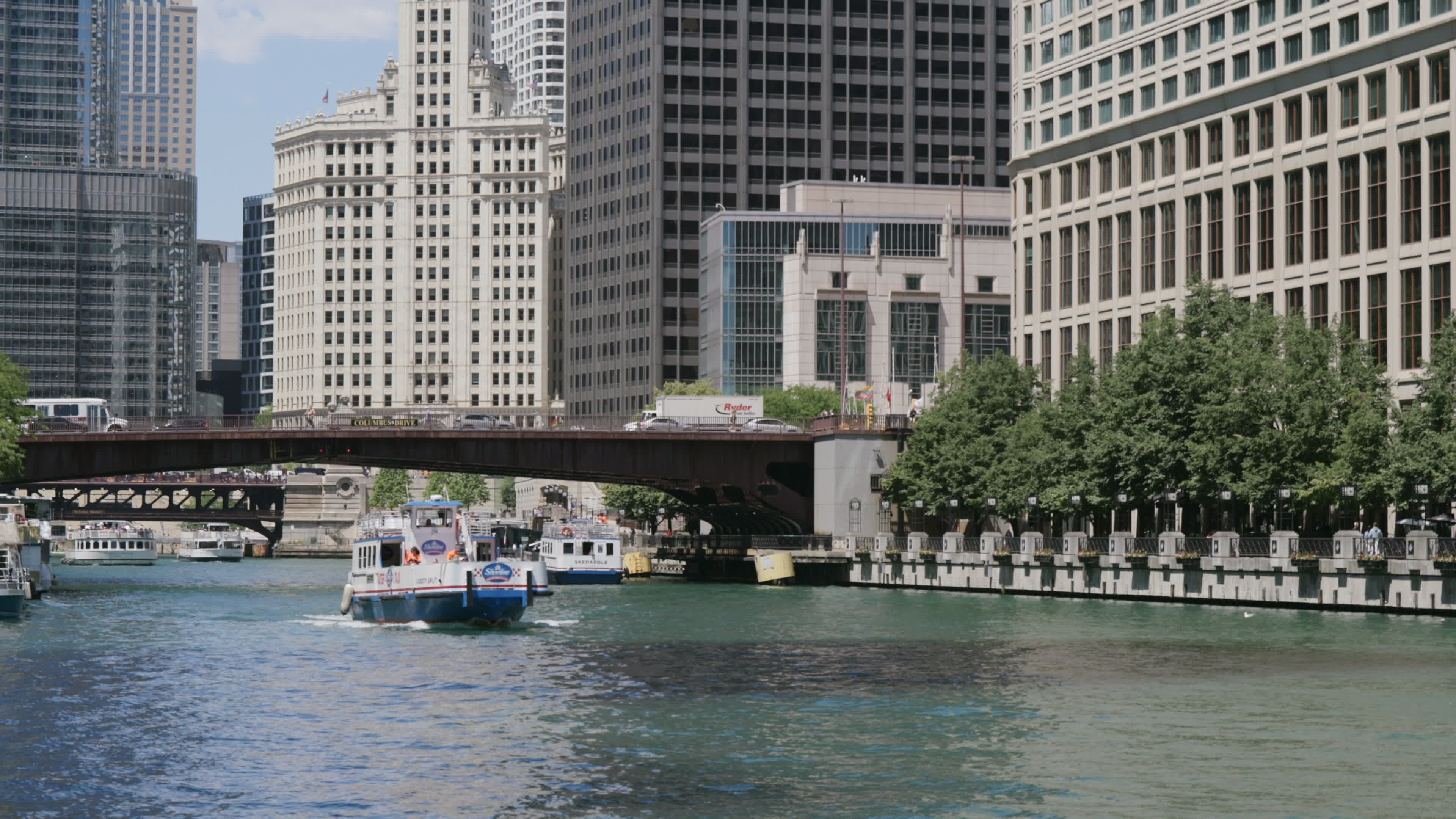 A boat traveling down the river in front of tall buildings Free Stock ...