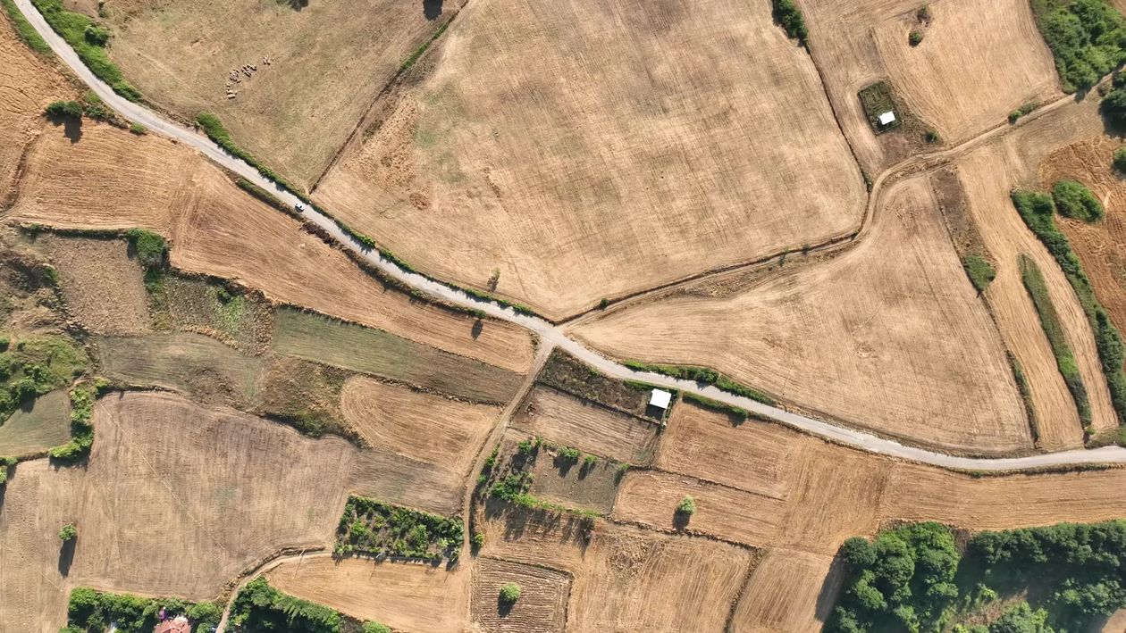 An aerial view of a field with a road Free Stock Video Footage, Royalty ...