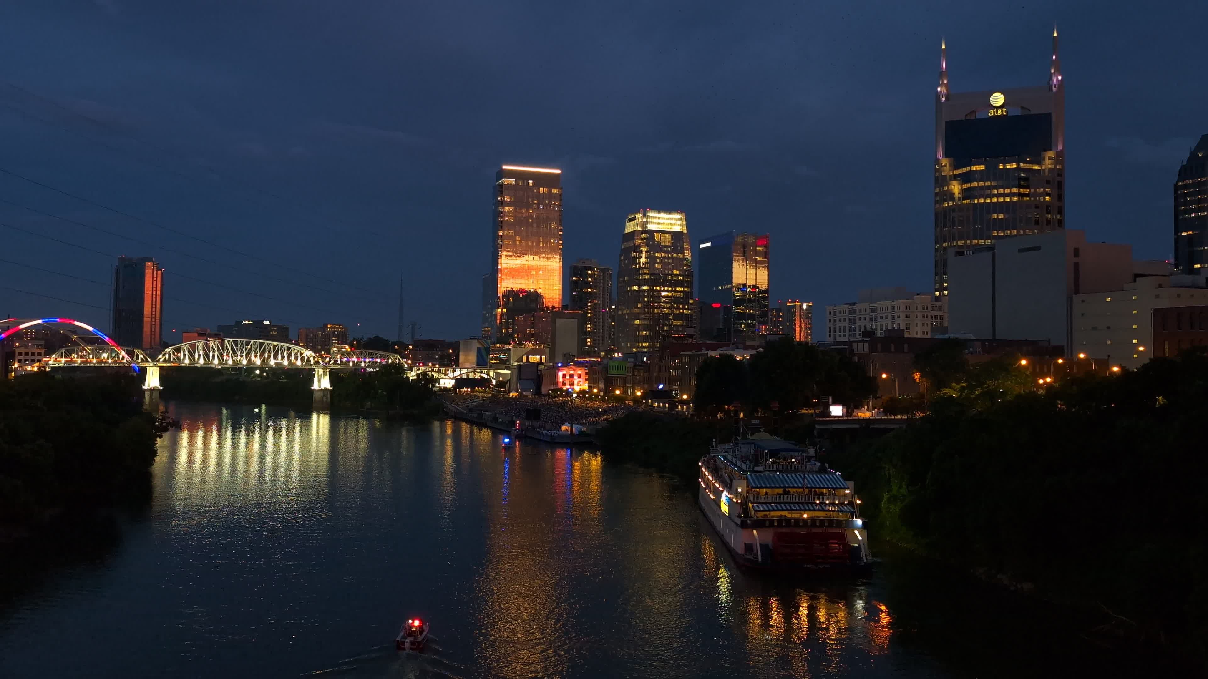 A city skyline at night with a river running through it Free Stock ...