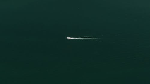 A Speedboat Traversing A Lake