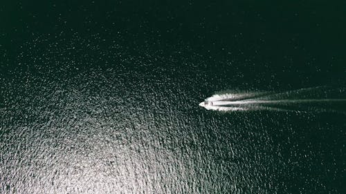 A Speedboat Traversing A Lake