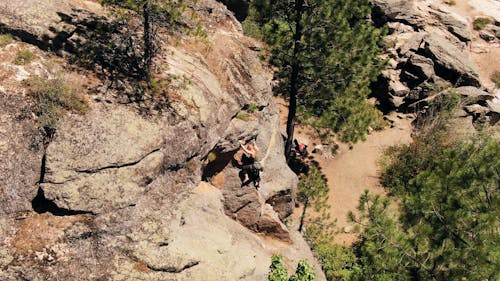 Woman Climbing The Mountain