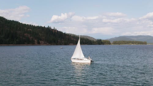 A Sailboat Floating In The Middle Of A Lake