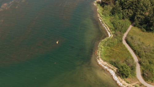 A Kayak Traversing A Lake